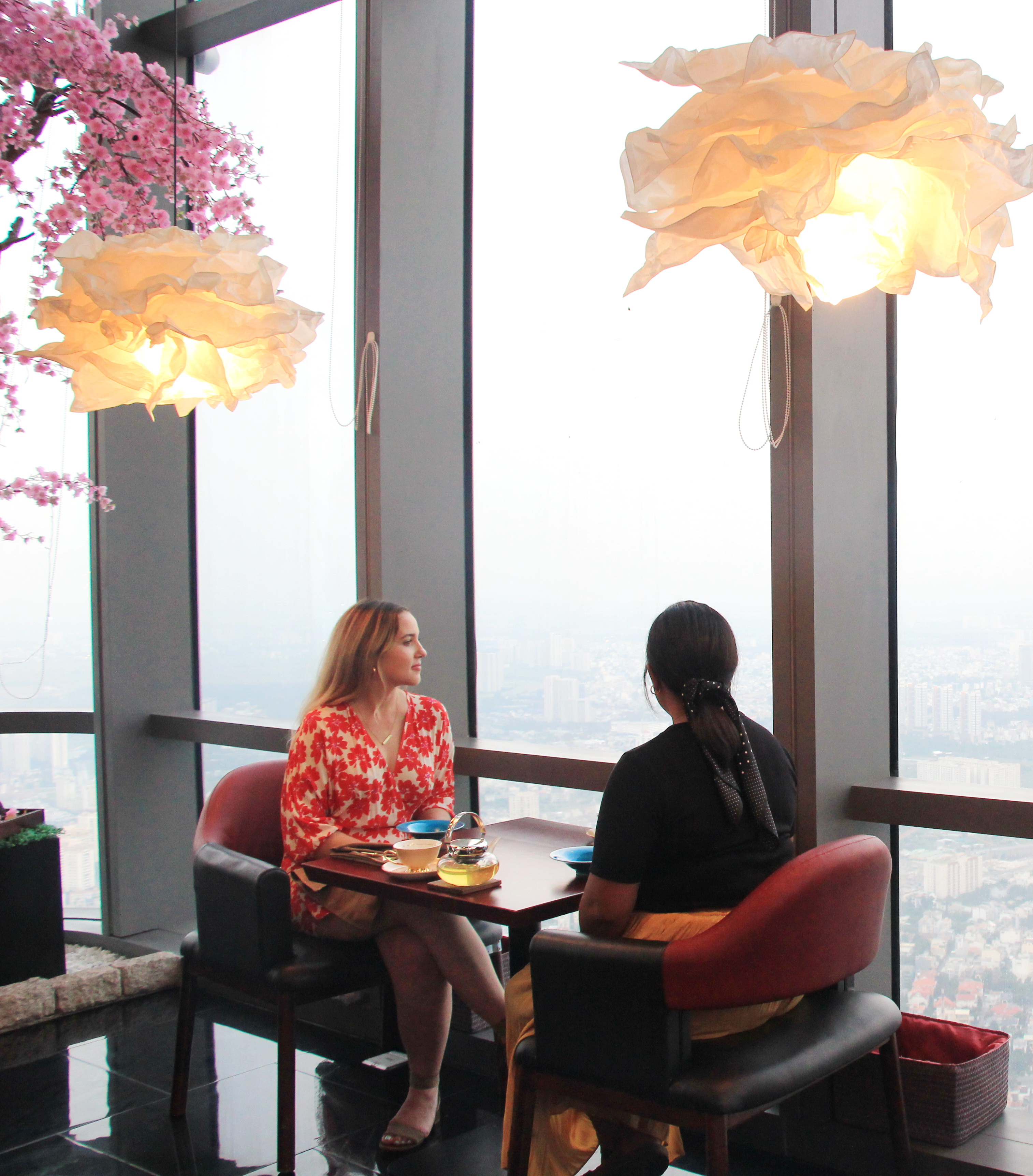  Dinners sit a a table by the glass window for a set of High Tea in the Sky afternoon tea at Miwaku Premium Restaurant on the 80th floor at the 81-story Landmark 81 in Ho Chi Minh City's Binh Thanh District on October 22, 2020. Photo: Dong Nguyen/ Tuoi Tre News