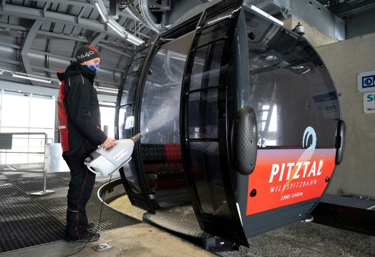 A worker disinfects a cable car cabin at Pitztal glacier, Austria on October 29, 2020. Photo: AFP