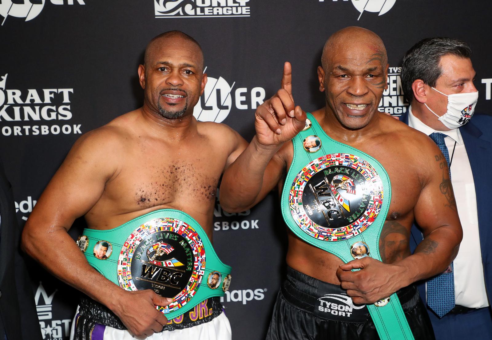 Nov 28, 2020; Los Angeles, CA, USA; Mike Tyson and Roy Jones, Jr. pose with their belts after a split draw during a heavyweight exhibition boxing bout for the WBC Frontline Belt at the Staples Center. Mandatory Credit: Joe Scarnici/Handout Photo via USA TODAY Sports