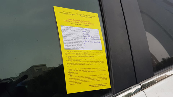 A parking ticket is stuck on a windshield of a car on a street in Hanoi on December 14, 2020. Photo: Quang Hieu