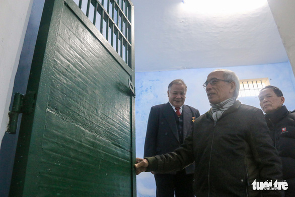 A former prisoner (middle) visits his cell in Thua Phu Prison.