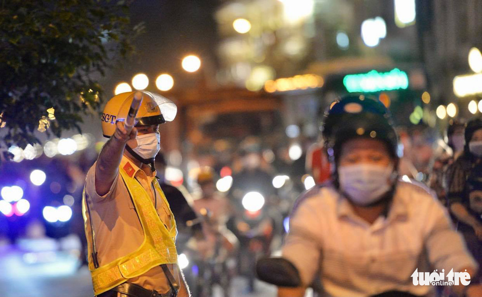 A traffic policeman orchestrates traffic at Bach Dang Port area in Ho Chi Minh City.