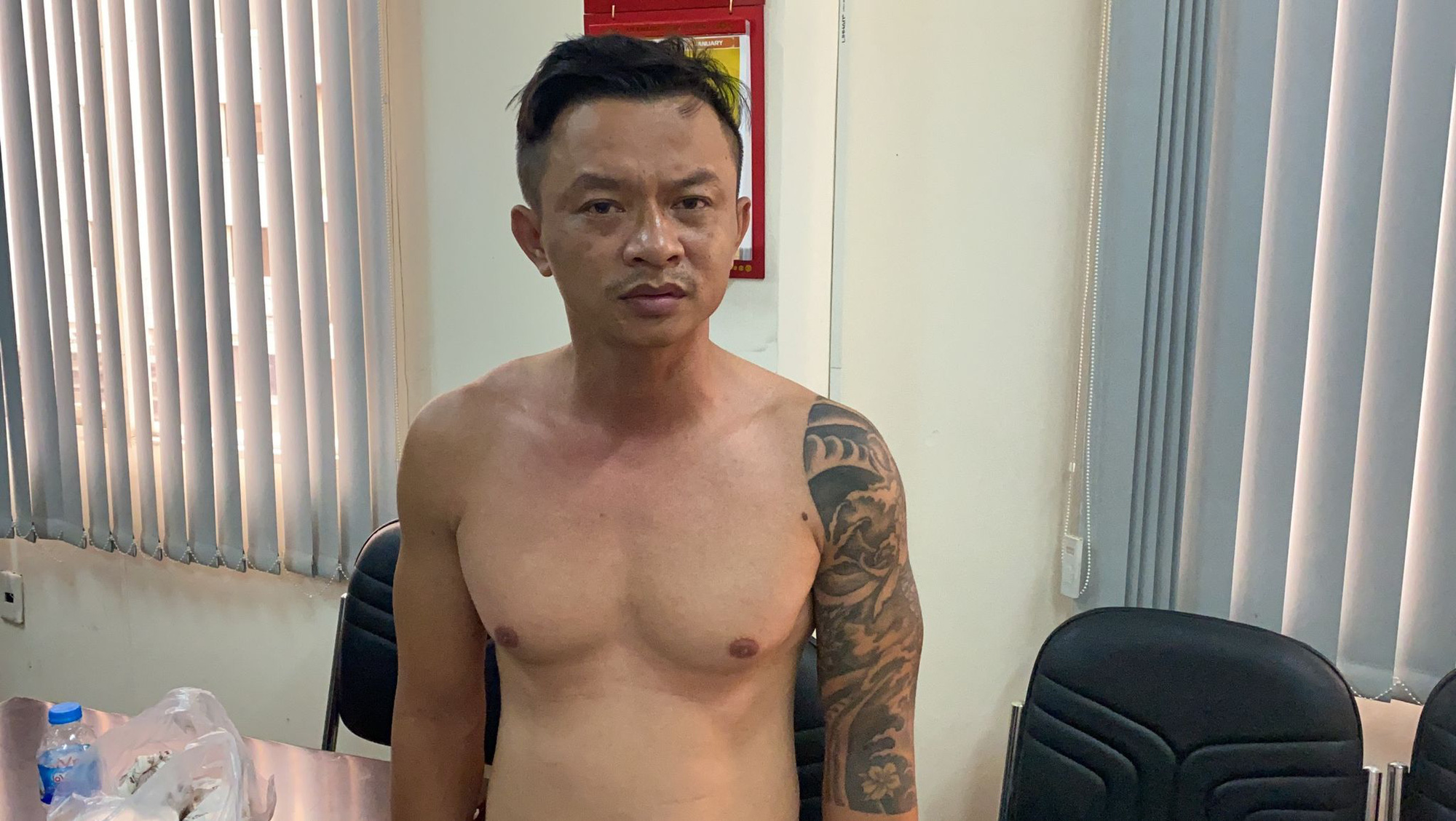 Nguyen Nhat Lam is held at a police station in Ho Chi Minh City, January 7, 2021. Photo: A.X. / Tuoi Tre