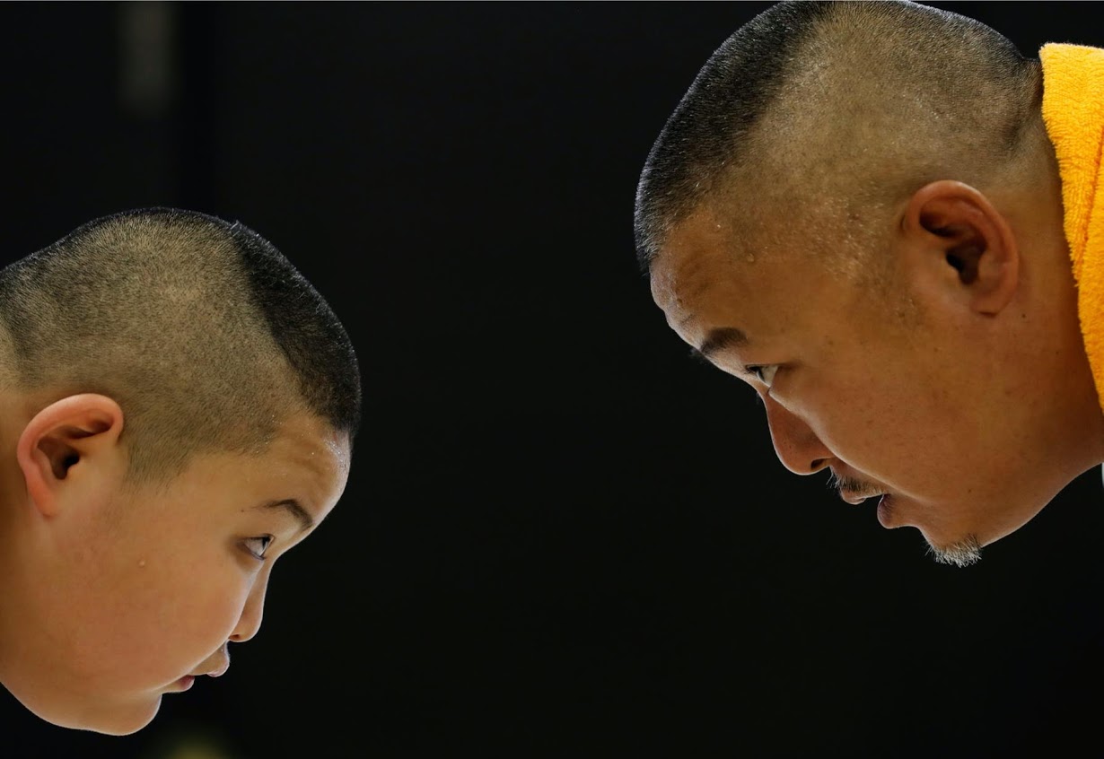 Kyuta practices sumo with his father during a one-on-one training session at the Buddhist temple Joshin-ji. Photo: Reuters