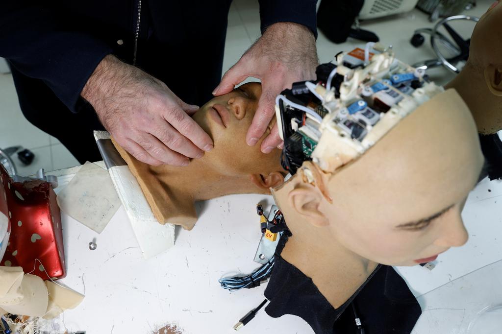 CEO David Hanson adjusts a face of a humanoid robot at Hanson Robotics' lab in Hong Kong, China January 12, 2021. Photo: Reuters