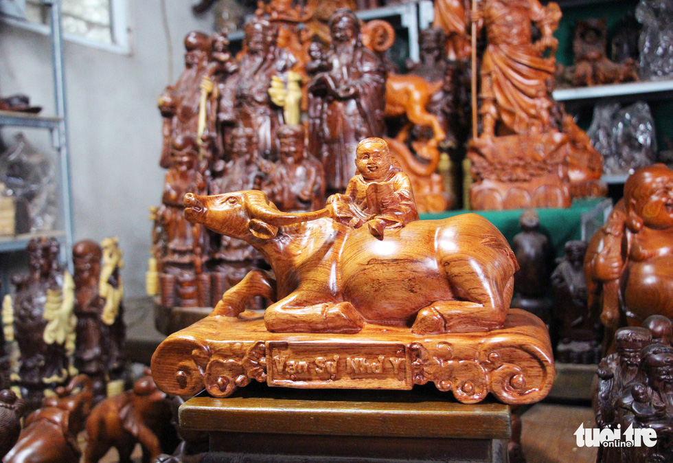 A wooden buffalo in a lying posture is pictured at Dinh Quan Village, Tien Phong Commune of Thuong Tin District, Hanoi. Photo: Ha Quan / Tuoi Tre