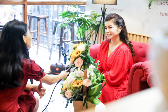 Le Hoang Diep Thao (right) talks with a reporter in an interview in a supplied photo