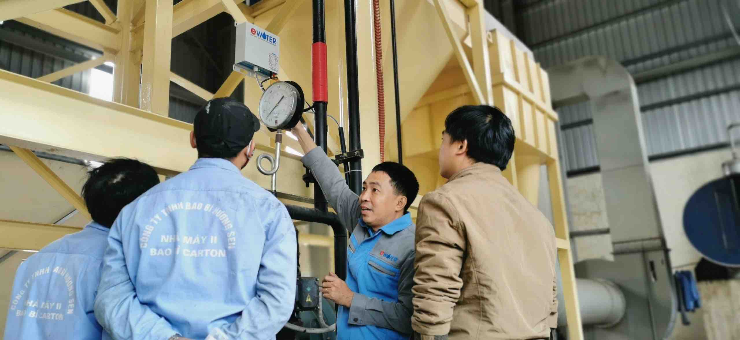 Le Trung Hieu sets up the Ewater filtration system with his associates at a factory in Vietnam. Photo: T.H.