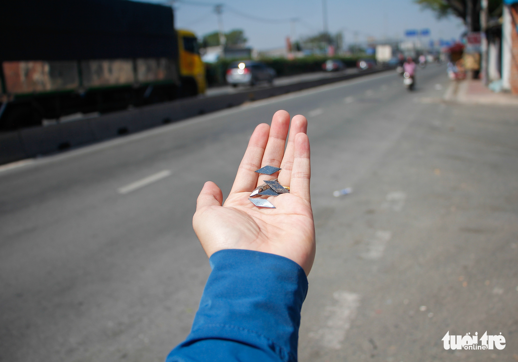 Tire-puncturing nails are found on a street in Ho Chi Minh City. Photo: Chau Tuan / Tuoi Tre