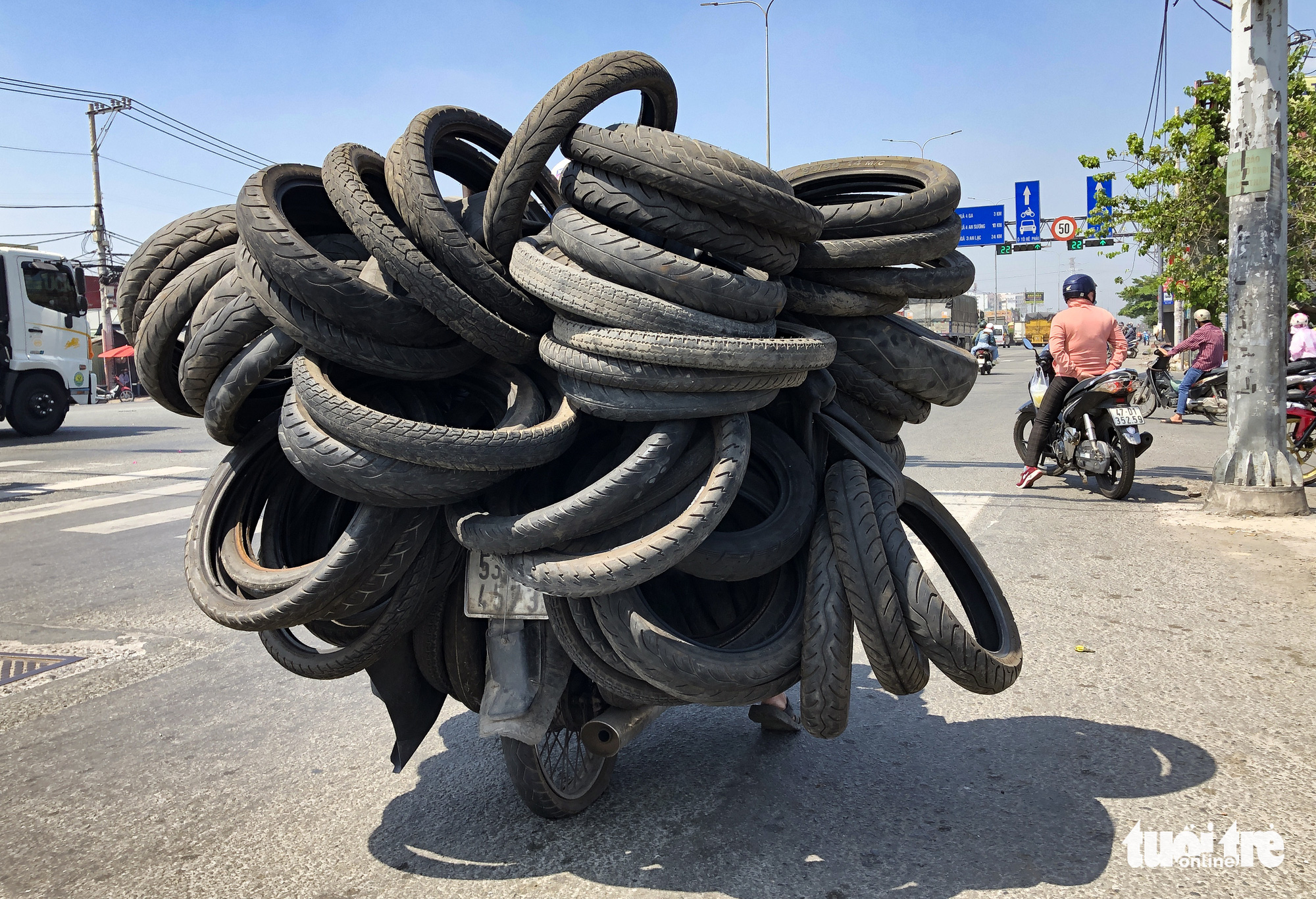 A motorbike has a flat tire after running over nails on a street in Ho Chi Minh City. Photo: Chau Tuan / Tuoi Tre