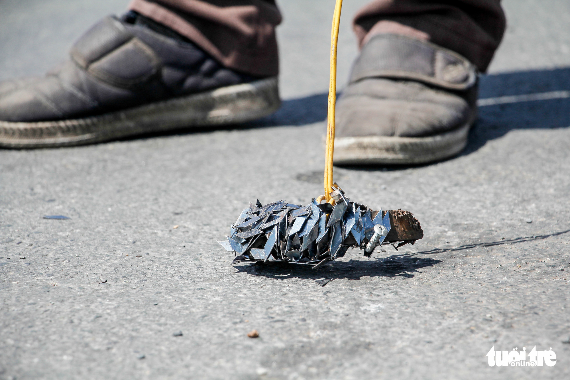 Tire-puncturing nails are collected from a street in Ho Chi Minh City. Photo: Chau Tuan / Tuoi Tre