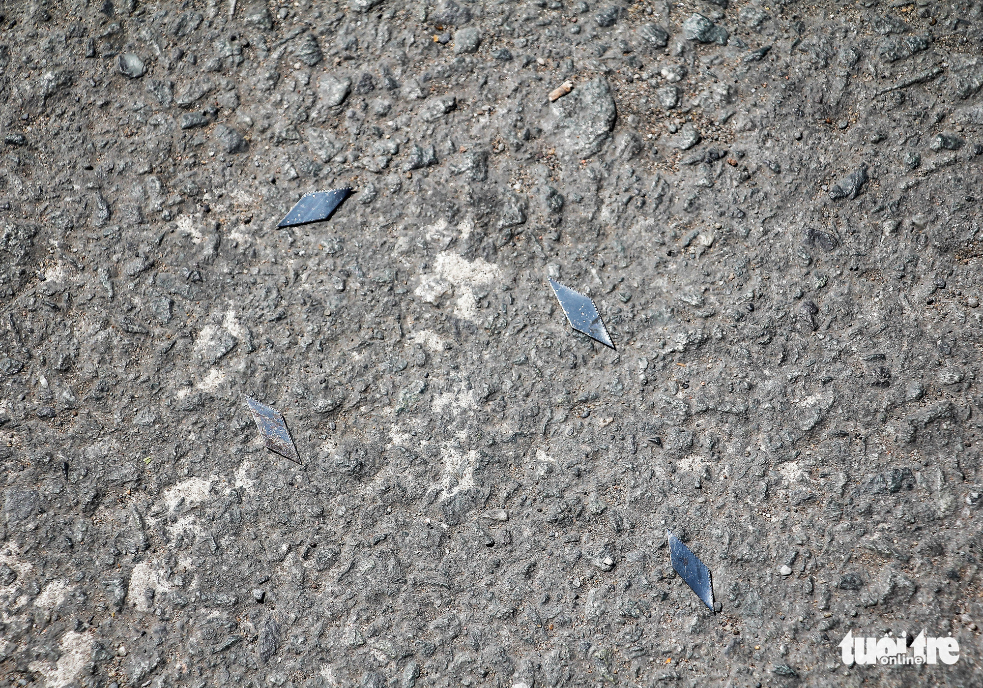 Tire-puncturing nails are found on a street in Ho Chi Minh City. Photo: Chau Tuan / Tuoi Tre
