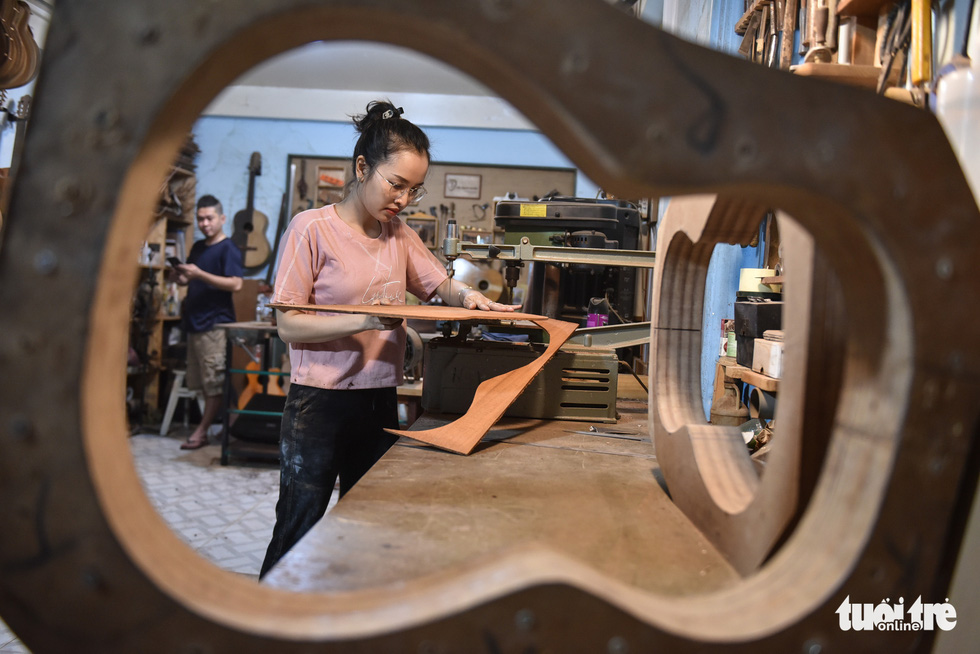 Thanh Tam makes the back of a guitar. Photo: Ngoc Phuong/Tuoi Tre