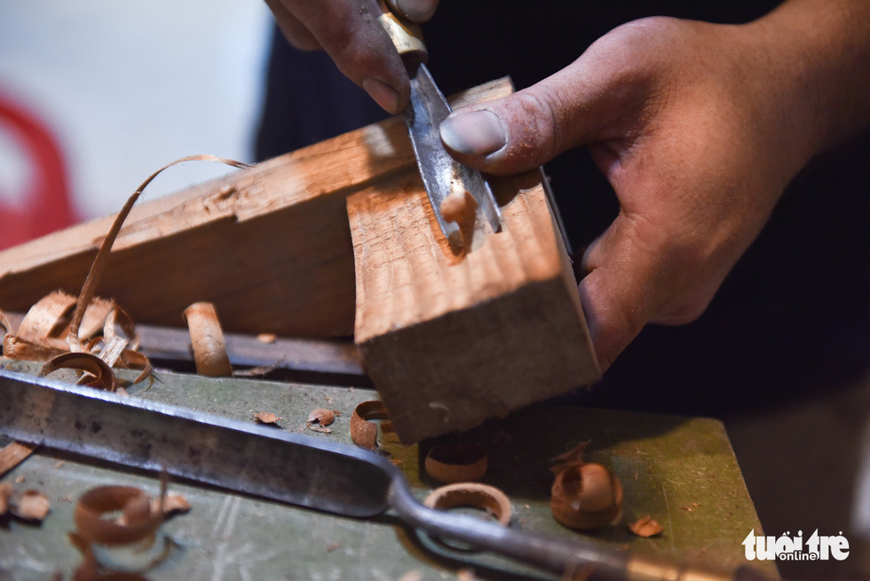 A piece of a guitar is carefully carved by hand. Photo: Ngoc Phuong/Tuoi Tre