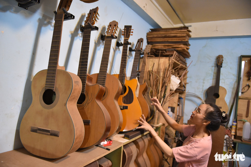Thanh Tam arranges guitars. They receive orders for classic guitars, acoustic guitars and electric guitars which range from dozens of millions Vietnam dong based on the materials and customers’ demands. Photo: Ngoc Phuong/Tuoi Tre