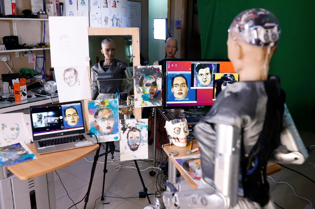 Humanoid robot Sophia, developed by Hanson Robotics, draws on a piece of paper before auctioning her own non-fungible token (NFT) artwork, in Hong Kong, China March 16, 2021. Photo: Reuters