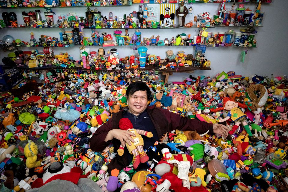 Percival Lugue, who has the Guinness world record for the largest fast-food toy collection, poses with his toy collection in his home in Apalit, Pampanga province, Philippines, April 20, 2021. Photo: Reuters