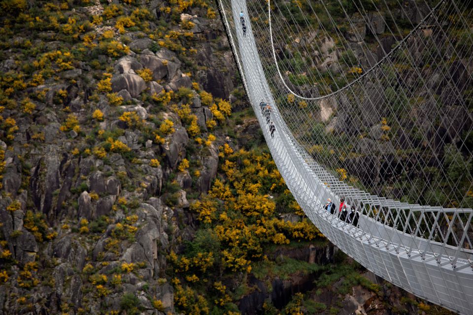 People walk on the world's longest pedestrian suspension bridge '516 Arouca', now open for local residents in Arouca, Portugal, April 29, 2021. Photo: Reuters