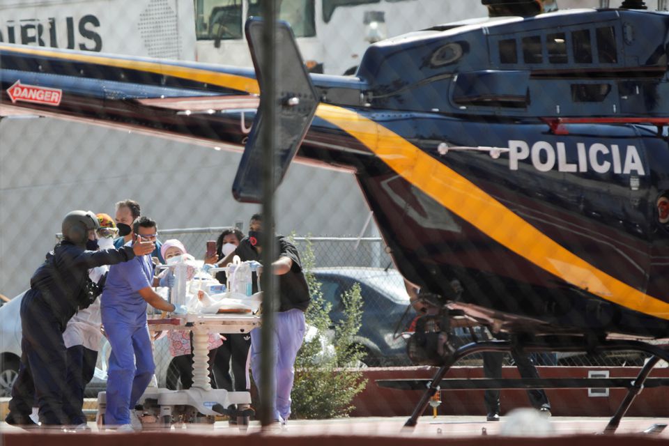 Paramedics transport Brandon Giovani Hernandez, who was injured during the accident where an overpass of the metro partially collapsed with train cars on it at Olivos station, toward a helicopter as he is transferred to another hospital, in Mexico City, Mexico May 4, 2021. Photo: Reuters