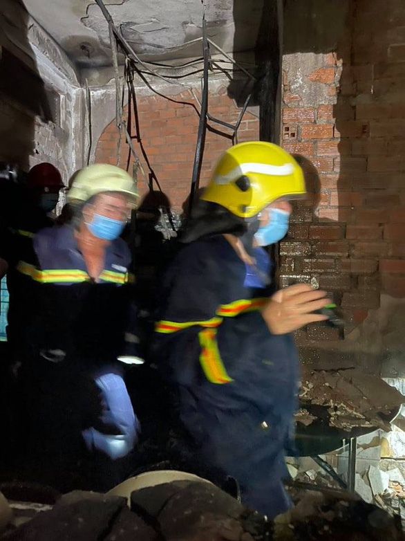 This supplied photo shows rescuers seeking victims at the fire scene.