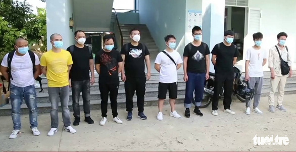 This image shows 10 Chinese men who have been found entering Vietnam illegally to seek way to return to China. Photo: Tuan Minh / Tuoi Tre