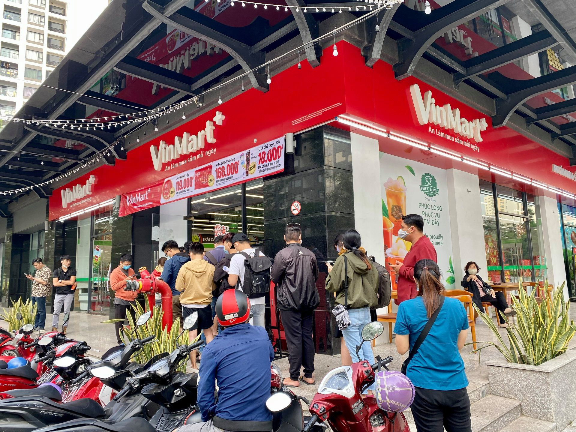 Customers line up in front of a Phuc Long kiosk at a VinMart+ store.