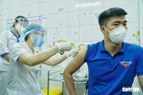 This image shows a man getting vaccination against coronavirus in Vietnam. Photo: Pham Tuan / Tuoi Tre