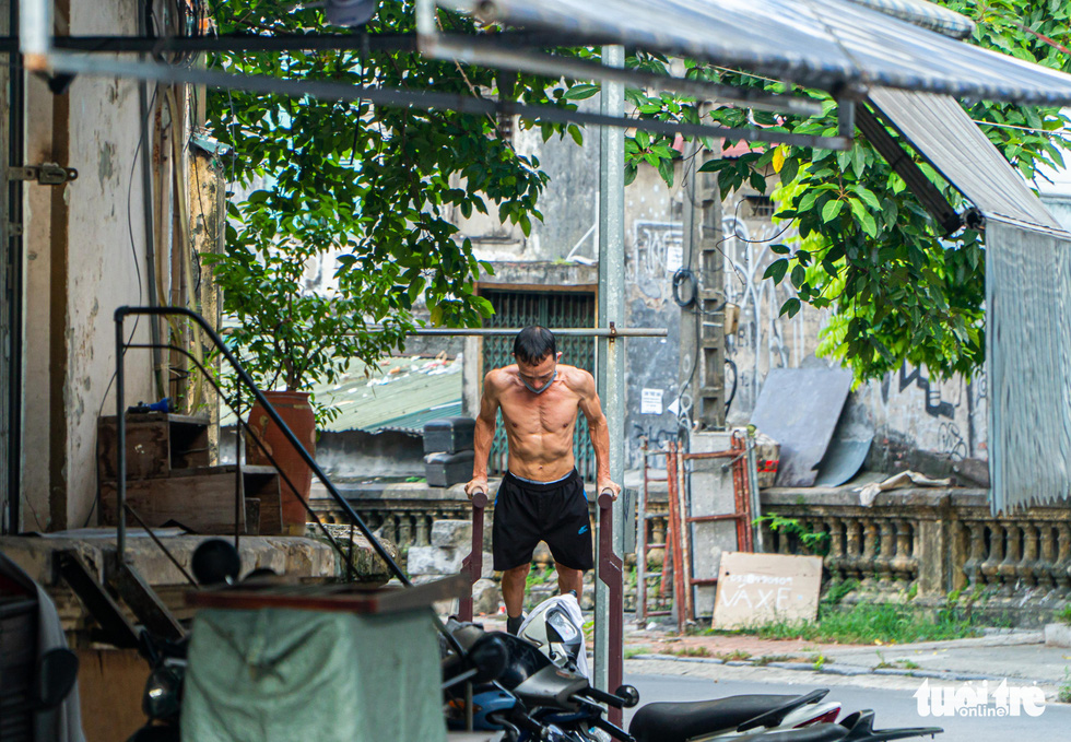 A man exercises near Long Bien Train Station in Hanoi, July 27, 2021. Photo: Pham Tuan / Tuoi Tre