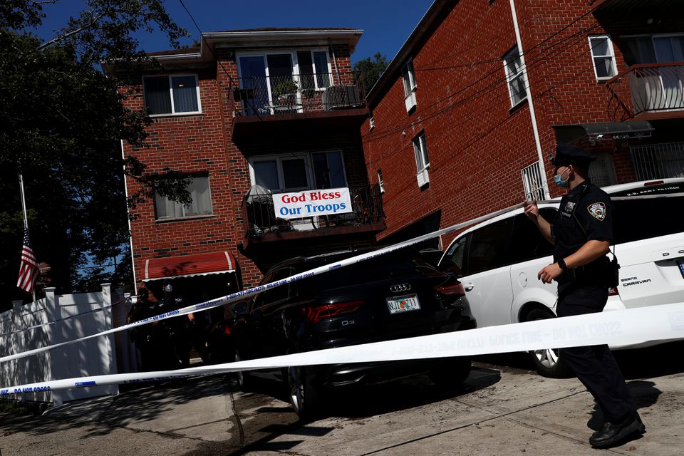 A member of the NYPD stands outside a residence, where three people, including a 2- year-old boy, were pronounced dead at the scene after being trapped in the basement of an apartment from floodwaters according to local media reports, after the remnants of Tropical Storm Ida brought drenching rain and flash floods in the Woodside section of the Queens borough of New York, U.S., September 2, 2021. Photo: Reuters