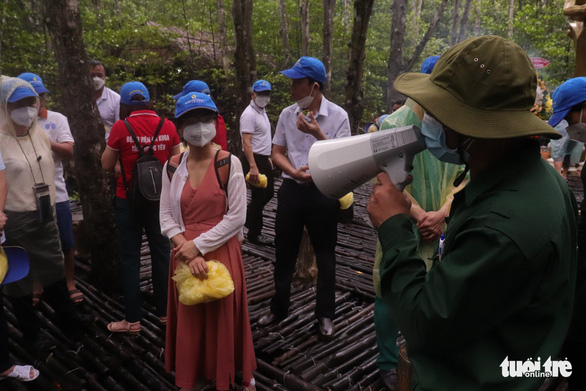 Visitors listen to a tour guide at Rung Sac Revolutionary Base in Can Gio District during a tour to pay tribute to medical workers from other localities that had come to assist Ho Chi Minh City in the fight against COVID-19 on September 19, 20201. Photo: Tuoi Tre
