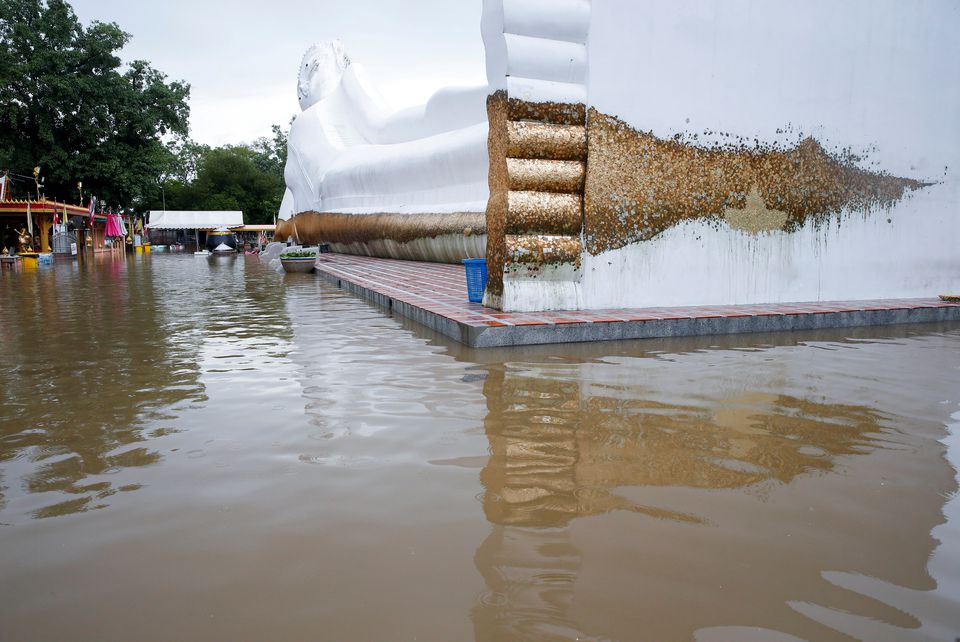 A lying Buddha statue is seen surrounded by floodwaters at a temple in Ayutthaya, Thailand, October 6, 2021. Photo: Reuters