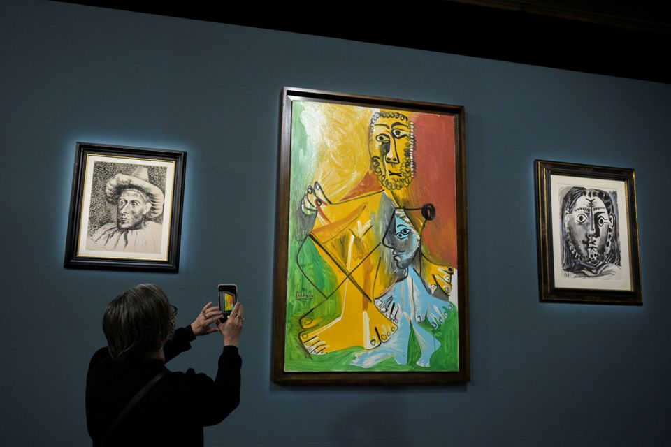 An attendee photographs a painting prior to the auction of 11 Picasso paintings and works at the Bellagio Hotel in Las Vegas, Nevada, U.S. October 23, 2021. Photo: Reuters