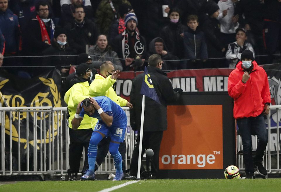 Soccer Football - Ligue 1 - Olympique Lyonnais v Olympique de Marseille - Groupama Stadium, Lyon, France - November 21, 2021 Olympique de Marseille's Dimitri Payet is hit by a water bottle thrown by a fan. Photo: Reuters