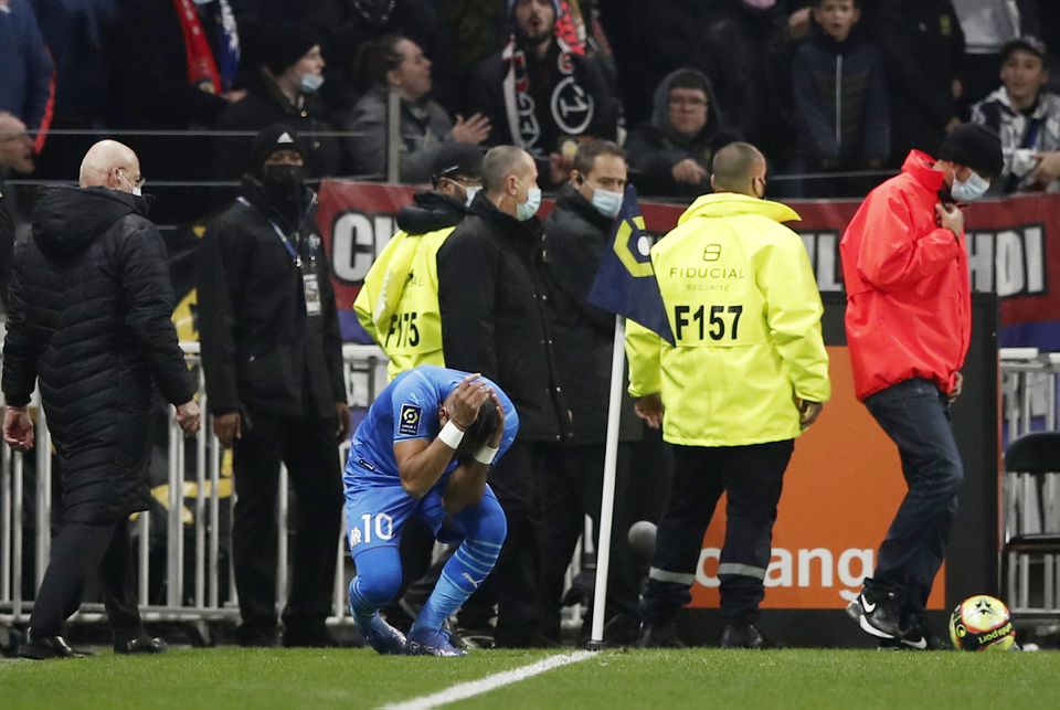 Soccer Football - Ligue 1 - Olympique Lyonnais v Olympique de Marseille - Groupama Stadium, Lyon, France - November 21, 2021 Olympique de Marseille's Dimitri Payet is hit by a water bottle thrown by a fan. Photo: Reuters