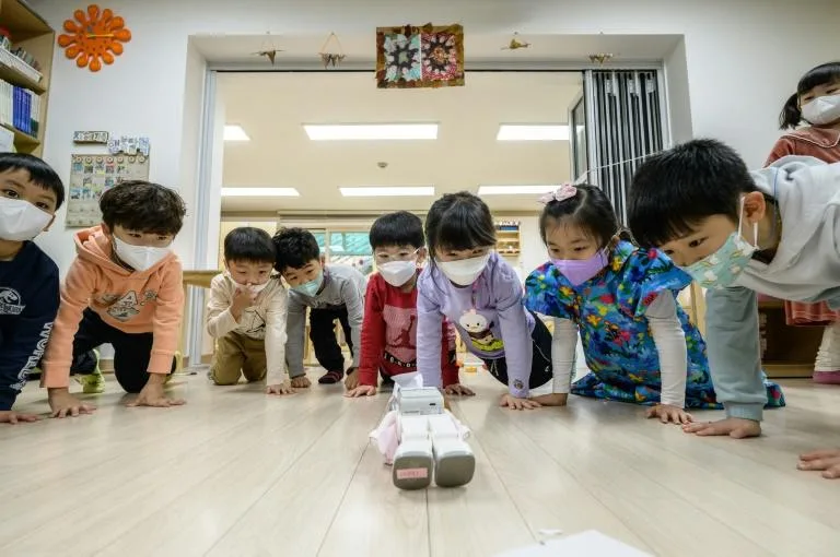 The 'Alpha Mini' teaches kung-fu moves as children mimic its push-ups. Photo: AFP