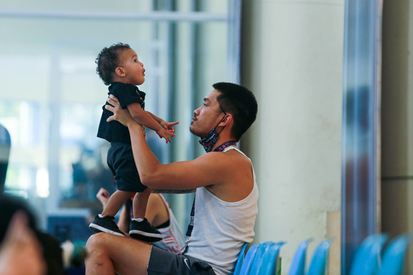The Vietnamese national basketball team’s Khoa Tran plays with a baby. Photo: VBA