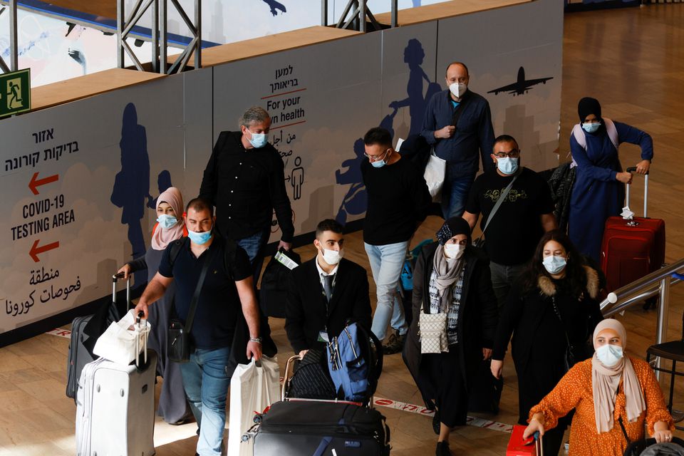 Travellers walk towards the coronavirus disease (COVID-19) pandemic testing area at Ben Gurion International Airport as Israel imposes new restrictions near Tel Aviv, Israel November 28, 2021. Photo: Reuters