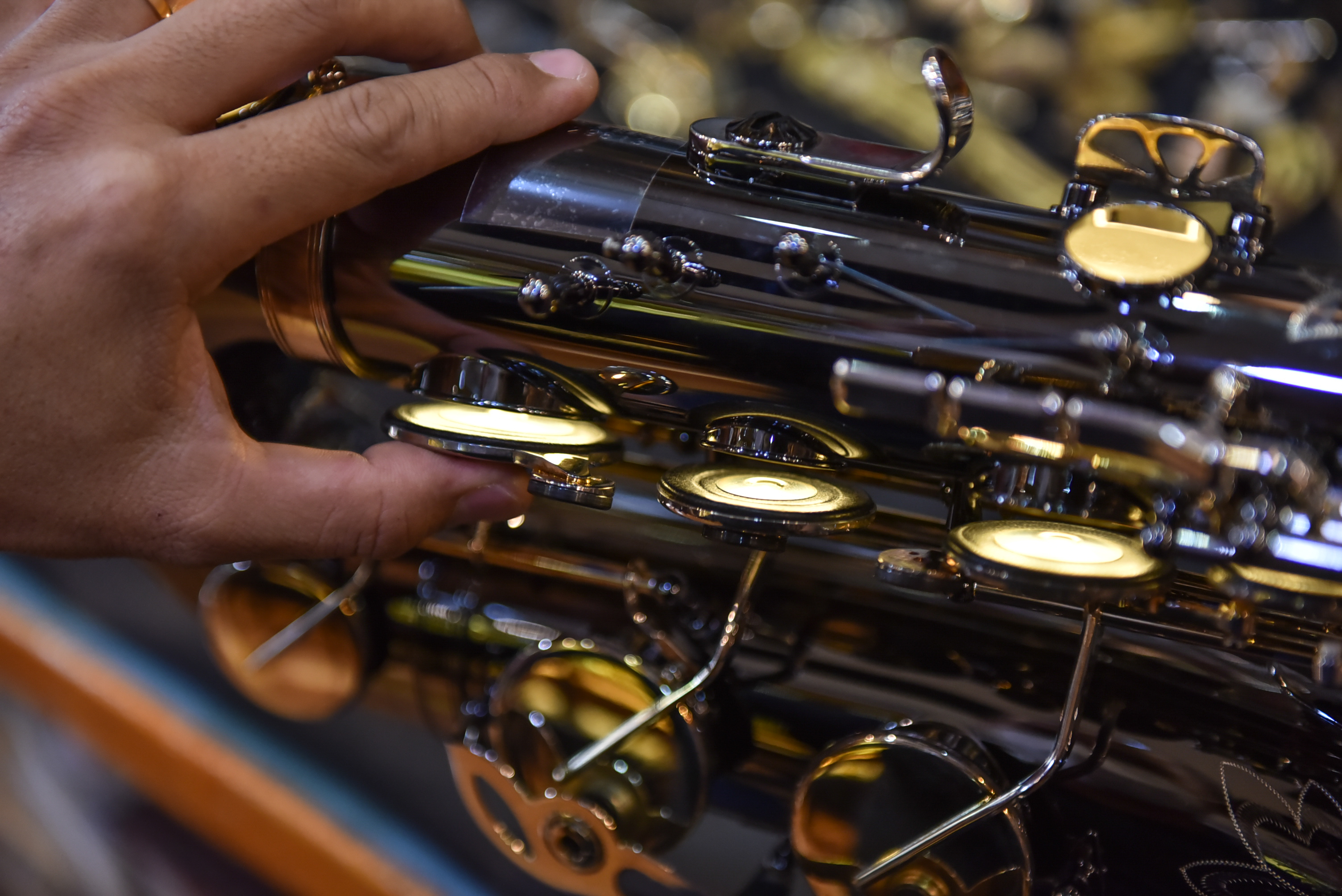 Nguyen Duy Khang checks on an instrument while repairing it at his repair shop in Tan Phu District in Ho Chi Minh City on December 6, 2021. Photo: Ngoc Phuong / Tuoi Tre News