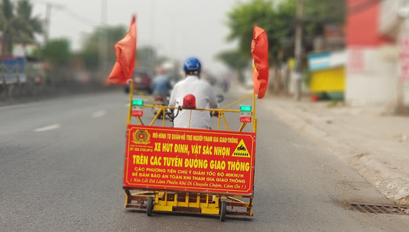 Dinh Minh Canh drives his specialized metal collecting vehicle along the National Highway No. 1, Binh Chanh District, Ho Chi Minh City.