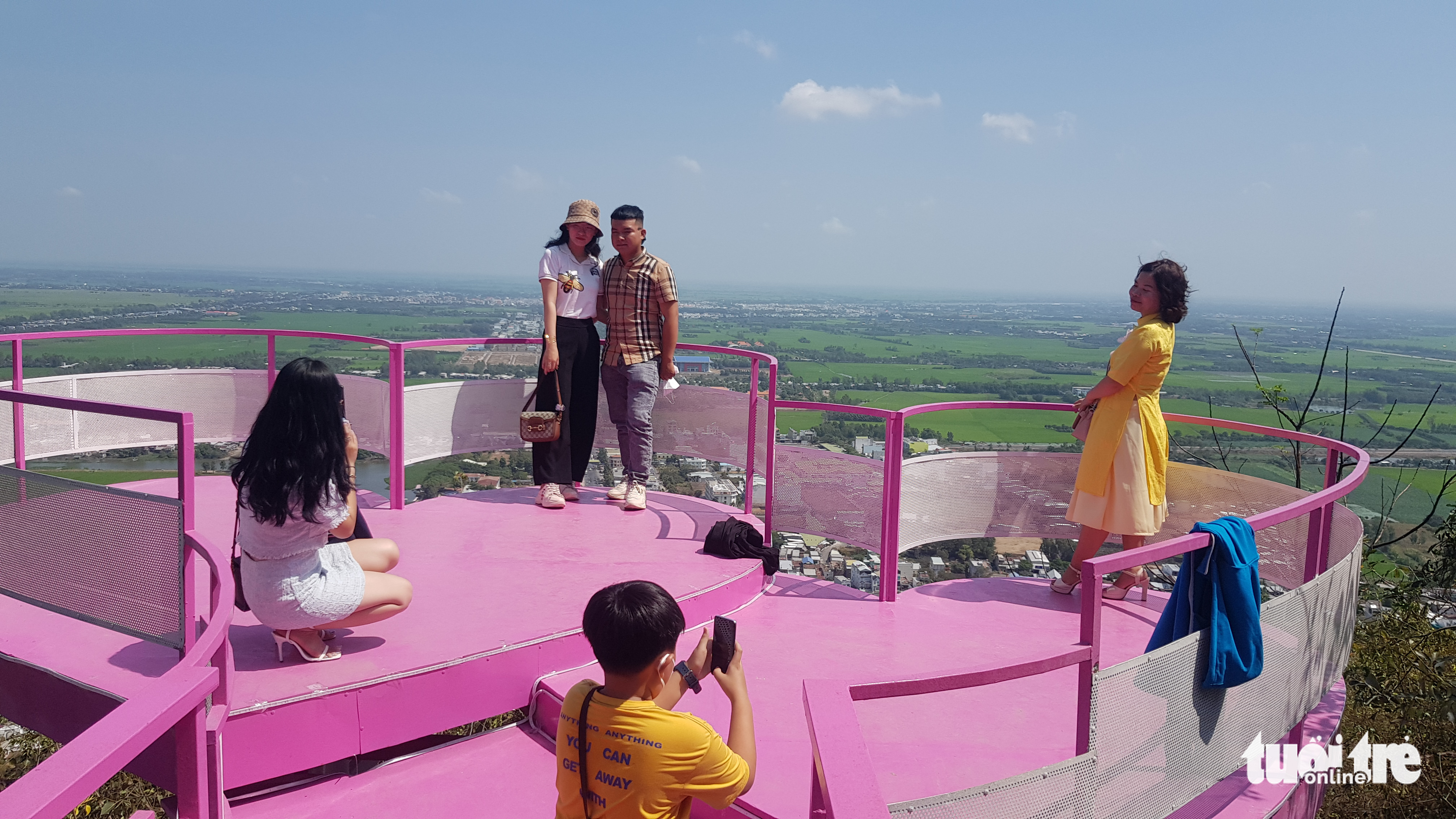 Visitors pose for a photo at the top of Sam Mountain in An Giang Province, Vietnam, February 1, 2022. Photo: Buu Dau / Tuoi Tre