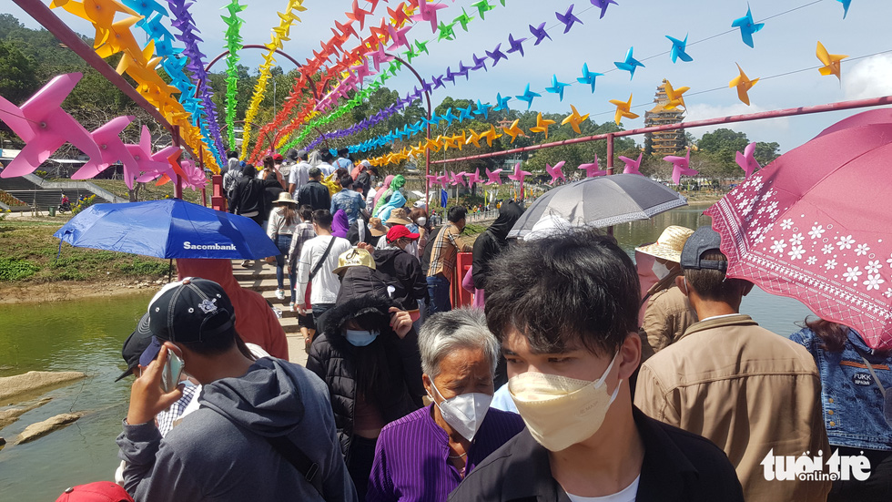 Visitors are seen at a pinwheel area on the top of Cam Mountain in Tinh Bien District, An Giang Province, Vietnam. Photo: Buu Dau / Tuoi Tre 