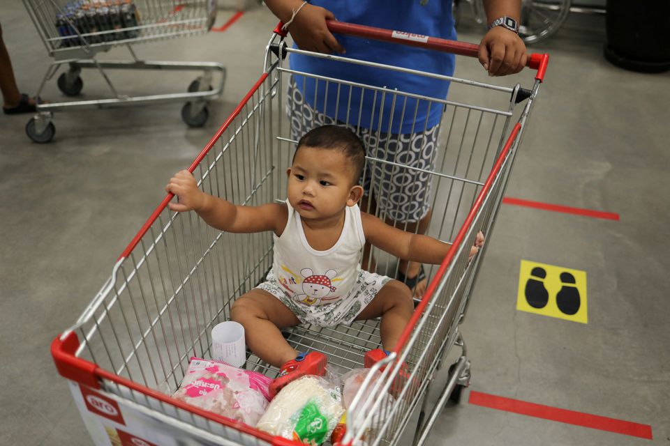 A baby is seen in a shopping cart after the government eased some protective measures following the coronavirus disease (COVID-19) outbreak, in Bangkok, Thailand June 19, 2020. Photo: Reuters