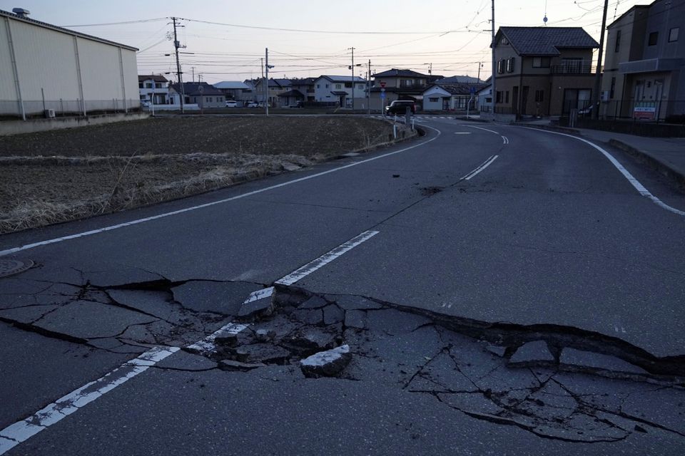 A broken road following a strong earthquake is pictured in Soma, Fukushima prefecture, Japan in this photo taken by Kyodo on March 17, 2022. Mandatory credit Kyodo/via Reuters