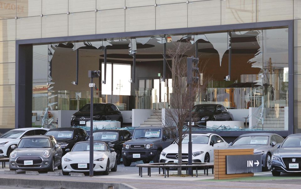 A car dealership's window is broken following a strong earthquake in Koriyama, Fukushima prefecture, Japan in this photo taken by Kyodo on March 17, 2022. Mandatory credit Kyodo/via Reuters