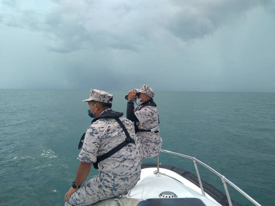 Malaysian Maritime Enforcement Agency (MMEA) officers search for the missing divers during the search and rescue operation off the Mersing coast, Johor, Malaysia, April 8, 2022. Malaysian Maritime Enforcement Agency/Handout via Reuters