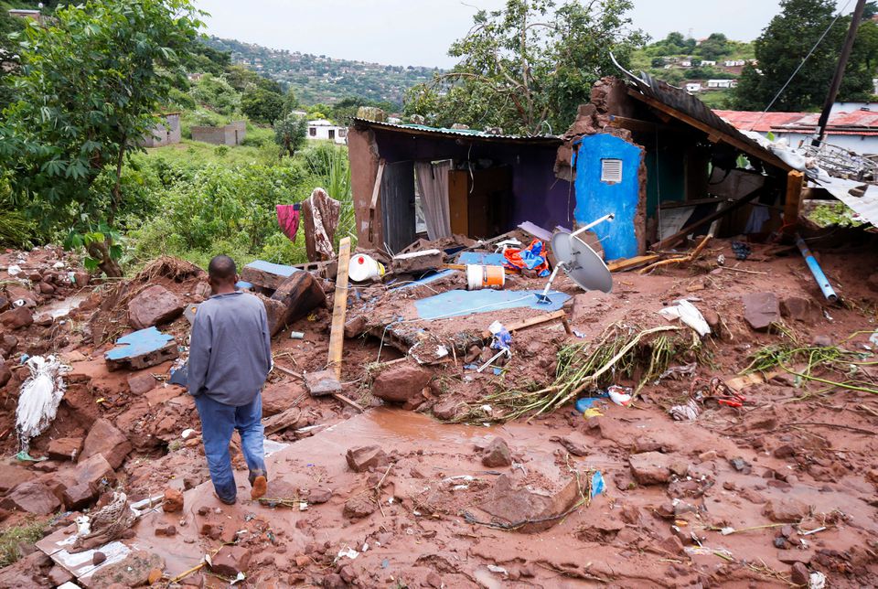 Jomba Phiri walks over where his house stood after heavy rains caused flood damage in KwaNdengezi, Durban, South Africa, April 12, 2022. Photo: Reuters