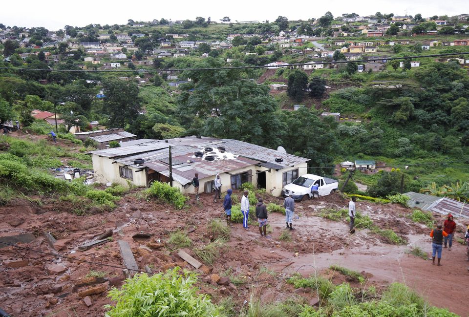 Residents begin mopping up operations after heavy rains caused flood damage in KwaNdengezi, Durban, South Africa, April 12, 2022. Photo: Reuters
