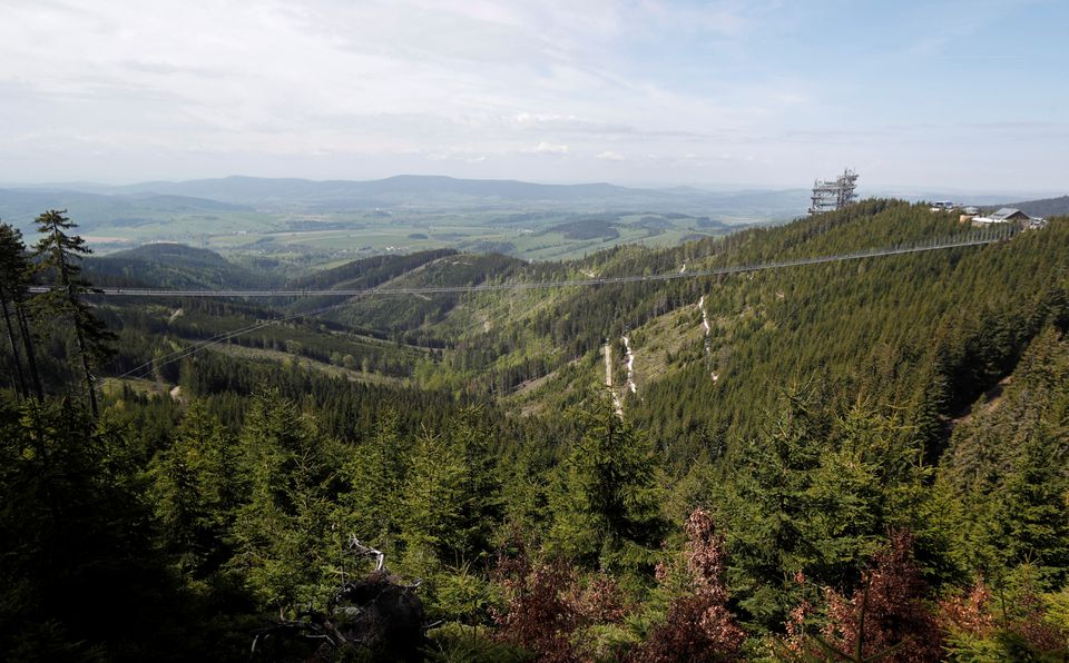 People walk across the newly-built world's longest suspension bridge after its official opening in the mountain resort of Dolni Morava, Czech Republic, May 13, 2022. Photo: Reuters