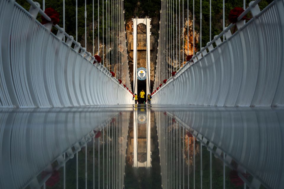 People walk on the Bach Long glass bridge during the opening ceremony at Moc Chau district in Son La province, Vietnam, May 28, 2022. Picture taken May 28, 2022. Photo: Reuters