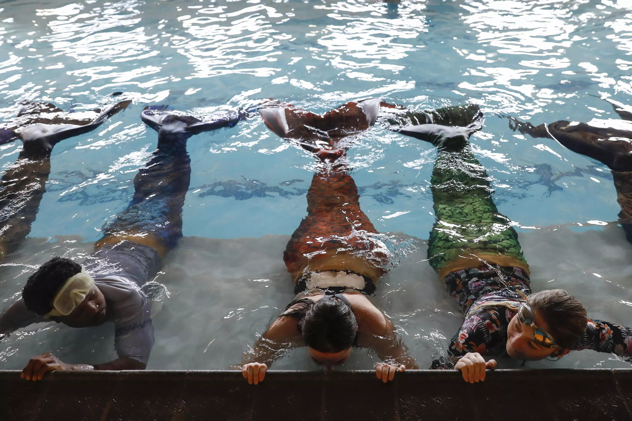 Students practise tail flips at the 'Merschool.' Photo: AFP